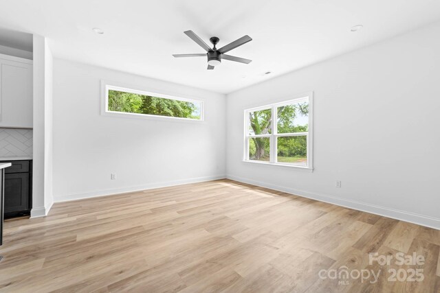 506 Legrand St, Shelby, NC 28150 - empty room featuring plenty of natural light, light wood finished floors, a ceiling fan, and baseboards