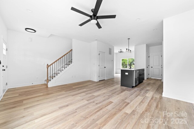 506 Legrand St, Shelby, NC 28150 - unfurnished living room with stairway, ceiling fan, light wood-style floors, and baseboards