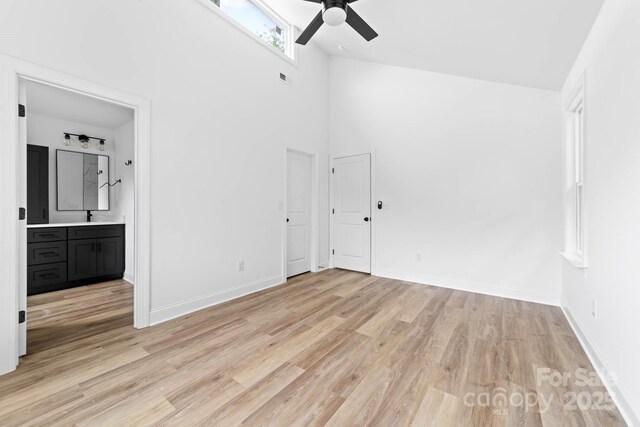 506 Legrand St, Shelby, NC 28150 - unfurnished bedroom featuring light wood-type flooring, a sink, baseboards, high vaulted ceiling, and connected bathroom