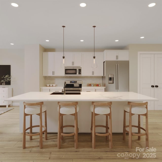 4965 Fitzgerald Ave, Charlotte, NC 28213 - kitchen with tasteful backsplash, appliances with stainless steel finishes, an island with sink, and white cabinetry