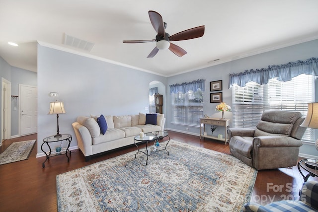 living area featuring visible vents, baseboards, arched walkways, a ceiling fan, and wood finished floors