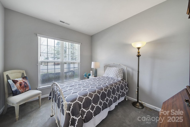 carpeted bedroom with baseboards and visible vents
