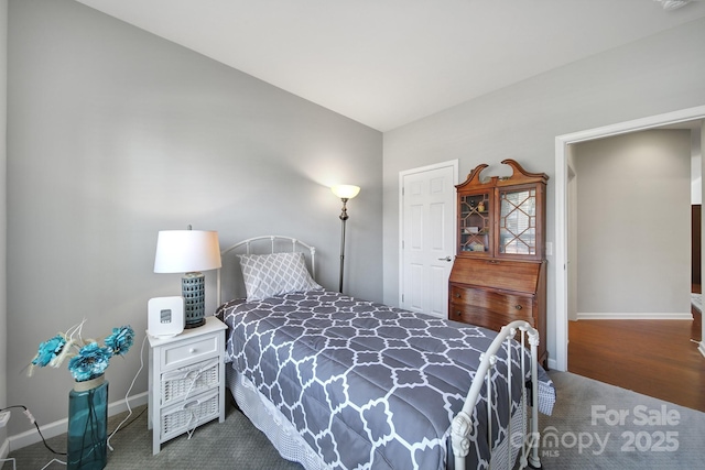 bedroom with carpet flooring and baseboards