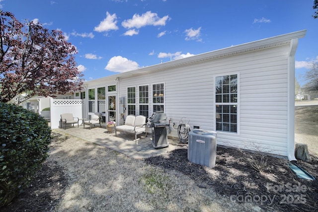 back of house with central AC, fence, and a patio