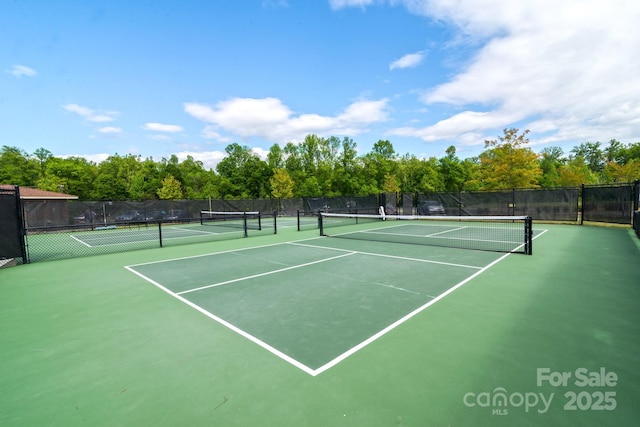 view of tennis court with fence and community basketball court