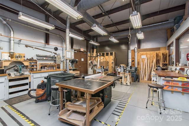 misc room with finished concrete floors and a workshop area