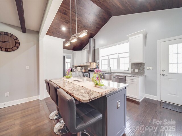 605 Allen Way, Indian Trail, NC 28079 - kitchen with wall chimney exhaust hood, appliances with stainless steel finishes, white cabinets, baseboards, and decorative backsplash