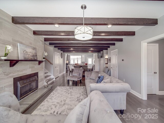 605 Allen Way, Indian Trail, NC 28079 - living area featuring baseboards, wood finished floors, beamed ceiling, a tiled fireplace, and recessed lighting