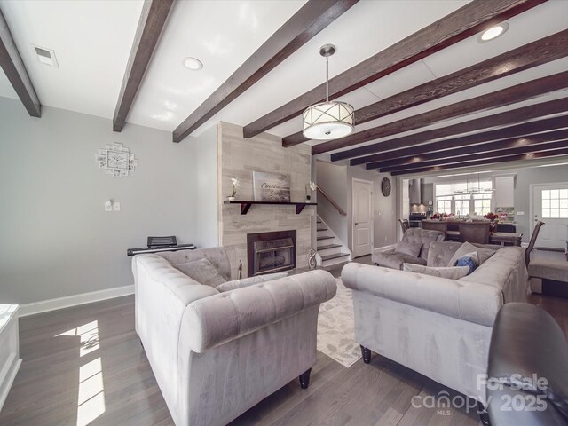605 Allen Way, Indian Trail, NC 28079 - living area featuring baseboards, dark wood finished floors, a tile fireplace, and beamed ceiling