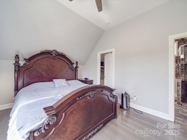 605 Allen Way, Indian Trail, NC 28079 - bedroom featuring light wood-type flooring, baseboards, lofted ceiling, a walk in closet, and ceiling fan