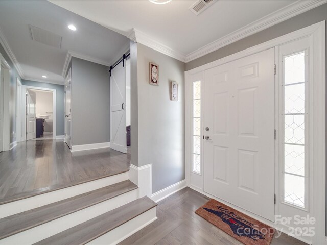 605 Allen Way, Indian Trail, NC 28079 - foyer featuring baseboards, crown molding, a barn door, recessed lighting, and healthy amount of natural light