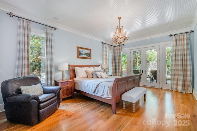 bedroom with access to outside, ornamental molding, french doors, light wood finished floors, and a notable chandelier