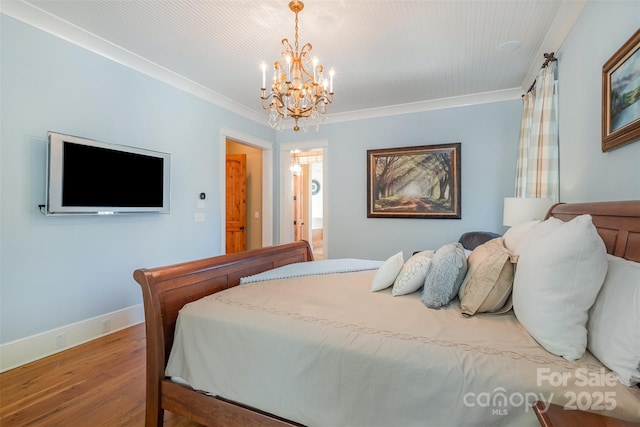 bedroom featuring a chandelier, crown molding, wood finished floors, and baseboards