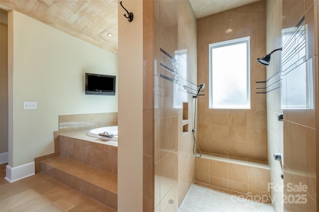 full bathroom featuring tiled shower, baseboards, a garden tub, and tile patterned flooring