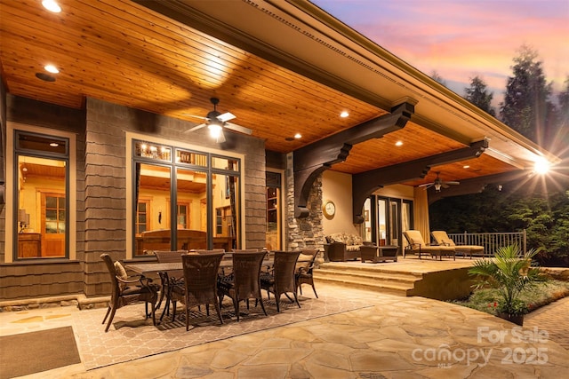patio terrace at dusk with ceiling fan and outdoor dining area