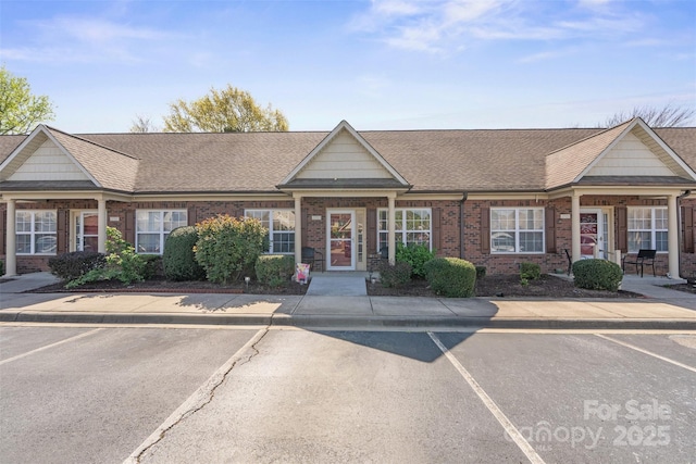 2783 Clover Rd NW, Concord, NC 28027 - view of property featuring brick siding, a shingled roof, and uncovered parking