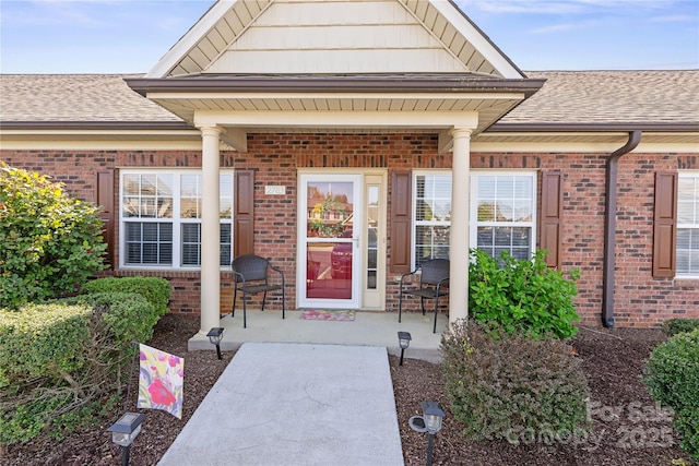 2783 Clover Rd NW, Concord, NC 28027 - property entrance with brick siding, roof with shingles, and a porch