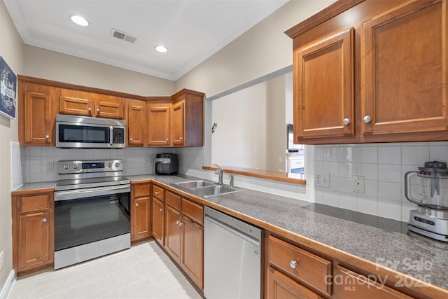 2783 Clover Rd NW, Concord, NC 28027 - kitchen featuring appliances with stainless steel finishes, crown molding, brown cabinetry, backsplash, and light tile patterned floors
