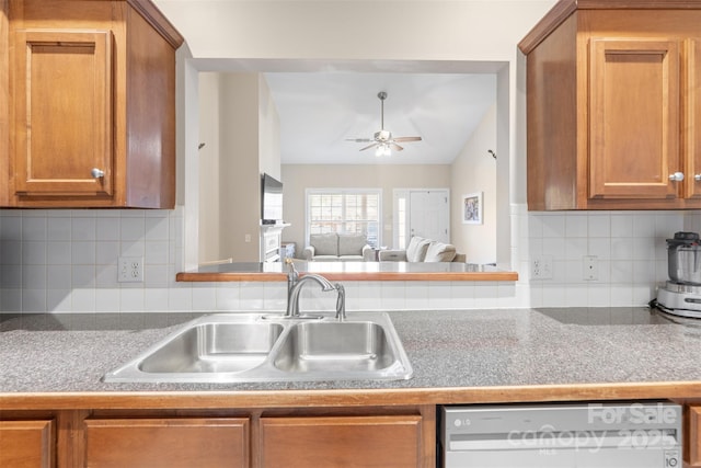 2783 Clover Rd NW, Concord, NC 28027 - kitchen with dishwasher, brown cabinetry, ceiling fan, tasteful backsplash, and vaulted ceiling