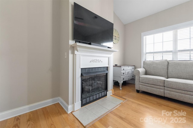 2783 Clover Rd NW, Concord, NC 28027 - living area featuring a tiled fireplace, wood finished floors, and lofted ceiling