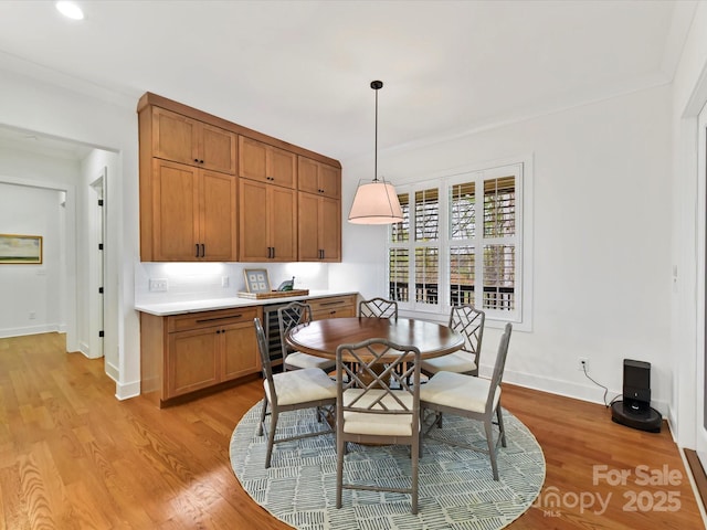911 Abilene Ln, Fort Mill, SC 29715 - dining area with baseboards, light wood finished floors, crown molding, beverage cooler, and recessed lighting
