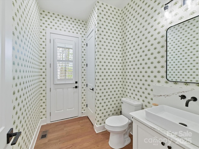 911 Abilene Ln, Fort Mill, SC 29715 - bathroom with wallpapered walls, wood finished floors, toilet, vanity, and baseboards