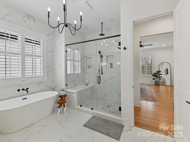 911 Abilene Ln, Fort Mill, SC 29715 - full bathroom with a marble finish shower, a freestanding tub, a ceiling fan, a chandelier, and marble finish floors