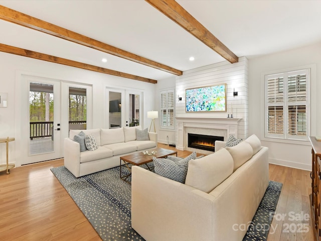 911 Abilene Ln, Fort Mill, SC 29715 - living room with french doors, light wood-style floors, a lit fireplace, beam ceiling, and recessed lighting