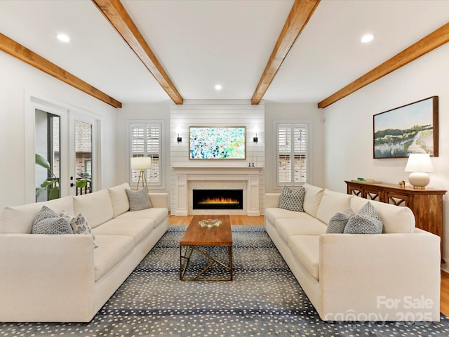 911 Abilene Ln, Fort Mill, SC 29715 - living room featuring wood finished floors, a lit fireplace, healthy amount of natural light, beamed ceiling, and recessed lighting