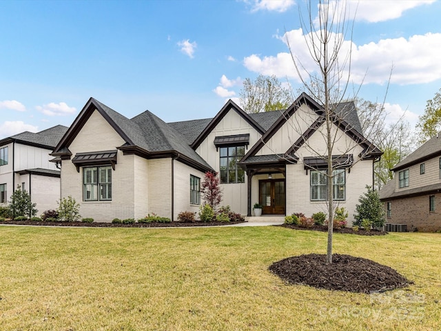 911 Abilene Ln, Fort Mill, SC 29715 - view of front of home with board and batten siding, french doors, a front lawn, brick siding, and a shingled roof