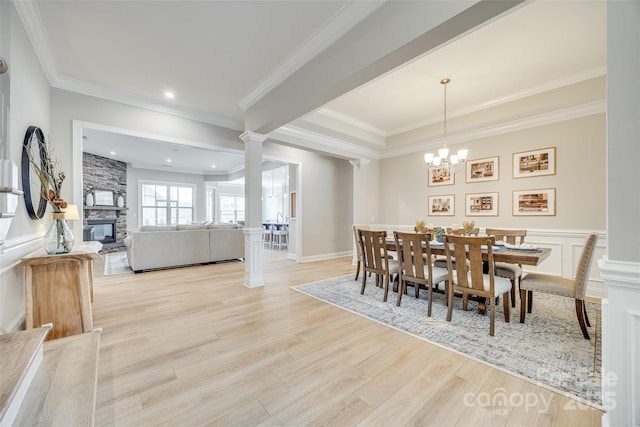 6207 Majesty Ct, Fort Mill, SC 29707 - dining space featuring a decorative wall, crown molding, ornate columns, wood finished floors, and wainscoting
