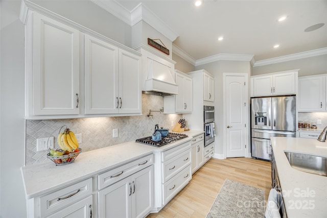 6207 Majesty Ct, Fort Mill, SC 29707 - kitchen with white cabinetry, a sink, ornamental molding, and appliances with stainless steel finishes