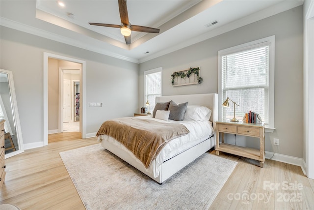 6207 Majesty Ct, Fort Mill, SC 29707 - bedroom featuring visible vents, baseboards, ornamental molding, light wood-style floors, and a tray ceiling