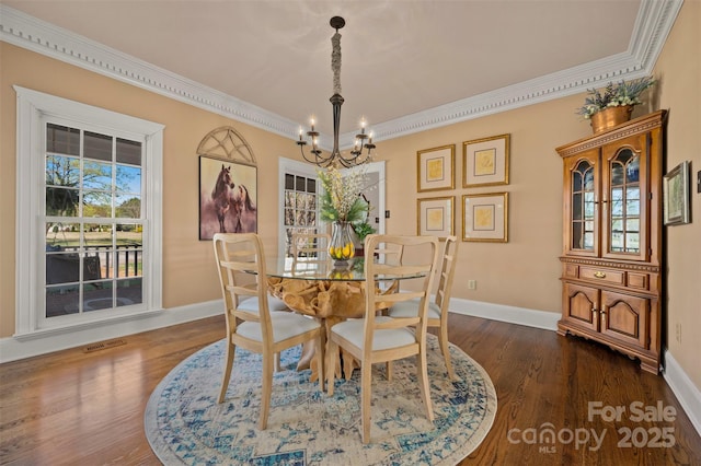 dining area featuring a notable chandelier, dark wood-type flooring, baseboards, and visible vents