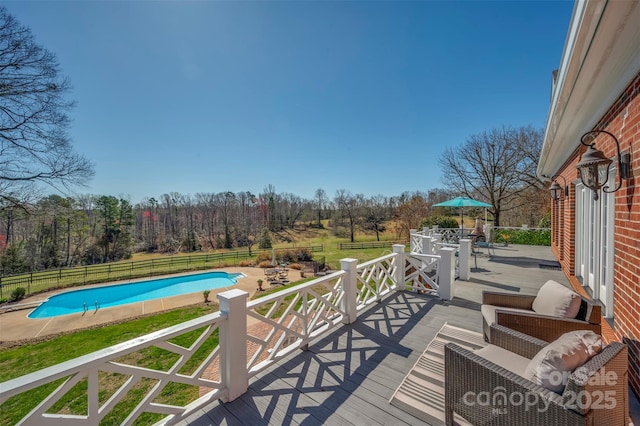 deck with a patio, a fenced in pool, a fenced backyard, outdoor dining space, and a yard