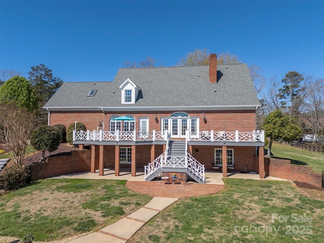rear view of property with a patio, brick siding, french doors, and a deck