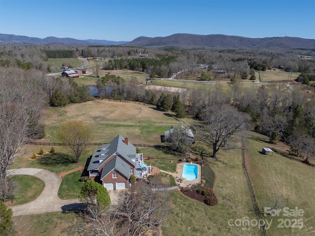 birds eye view of property with a mountain view and a rural view