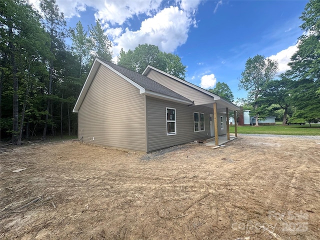 318 Stanback St, Mount Gilead, NC 27306 - view of side of home featuring roof with shingles