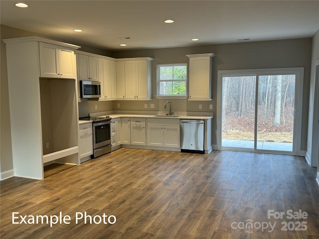 318 Stanback St, Mount Gilead, NC 27306 - kitchen with stainless steel appliances, recessed lighting, light countertops, white cabinetry, and dark wood-style flooring