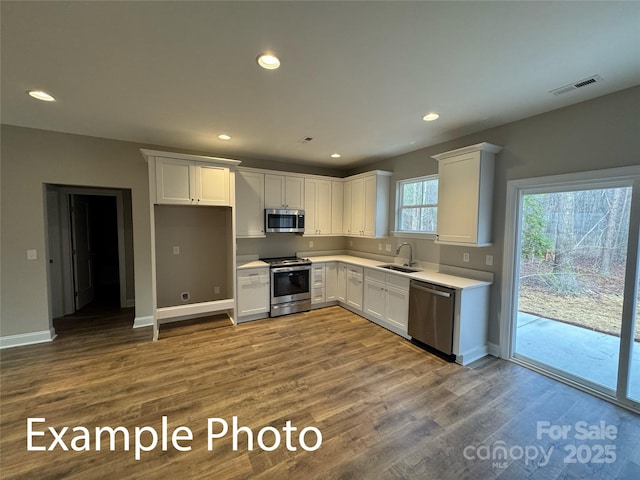 318 Stanback St, Mount Gilead, NC 27306 - kitchen with stainless steel appliances, white cabinetry, dark wood-type flooring, light countertops, and recessed lighting