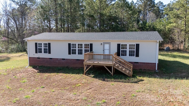 view of front of property featuring stairs, roof with shingles, crawl space, a deck, and a front lawn