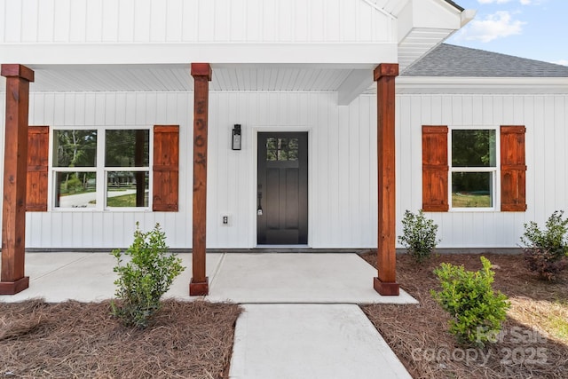 property entrance with a porch and a shingled roof