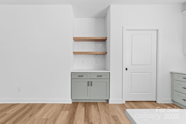 interior space featuring baseboards and light wood-style flooring