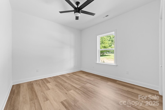 spare room with a ceiling fan, baseboards, visible vents, and light wood finished floors