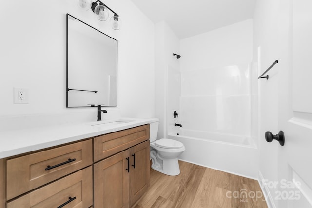 full bath featuring vanity, shower / bathing tub combination, toilet, and wood finished floors