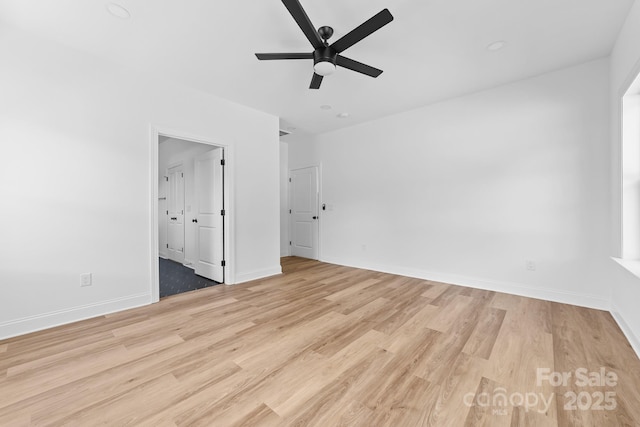 unfurnished bedroom featuring light wood-style floors, baseboards, and ceiling fan
