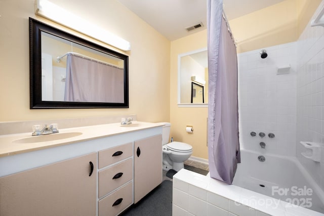 bathroom featuring visible vents, toilet, shower / tub combo with curtain, and a sink