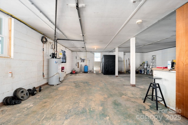 below grade area with concrete block wall and water heater