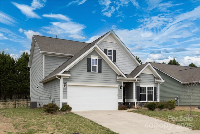 view of front of home with roof with shingles, fence, driveway, central AC unit, and a garage