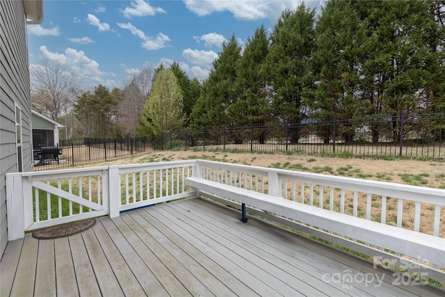 wooden terrace featuring a fenced backyard